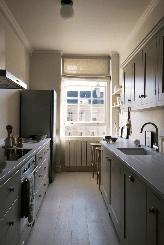 A grey shaker kitchen with a breakfast bar in a galley layout, from deVOL kitchens