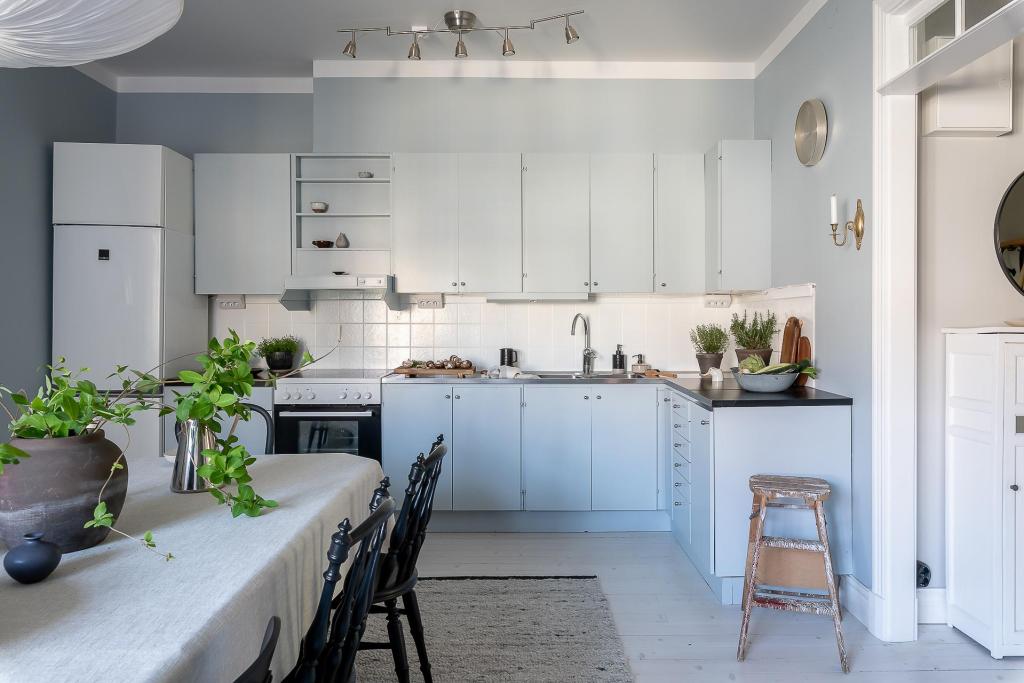 A light blue kitchen paired with light blue walls