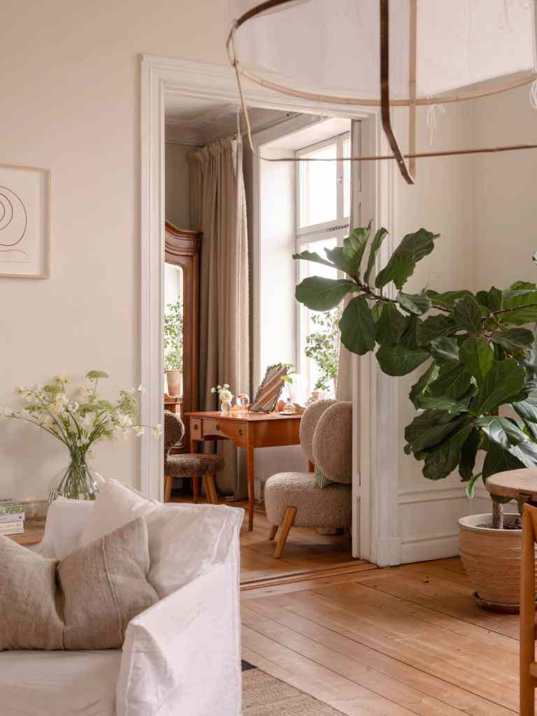 A living room with off-white walls and warm wood tones