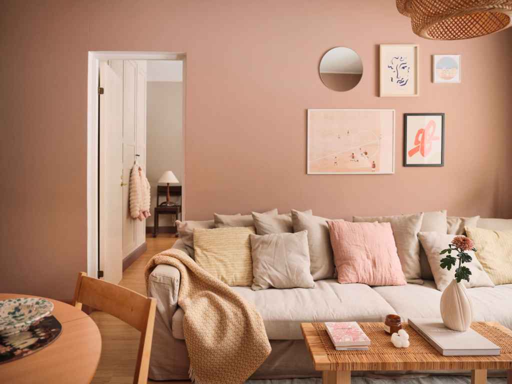 A blush pink living room with warm toned accessories