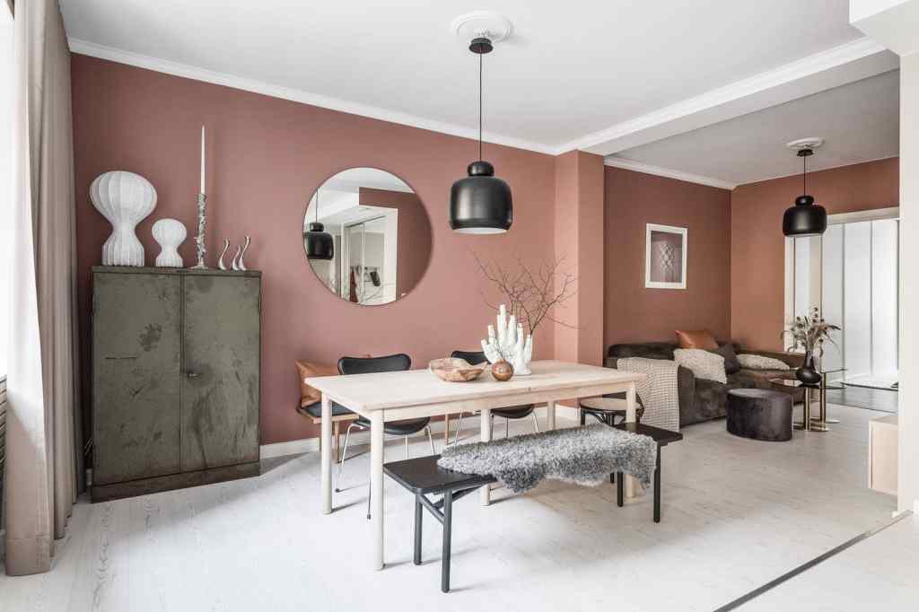 A lipstick pink living room with black accents