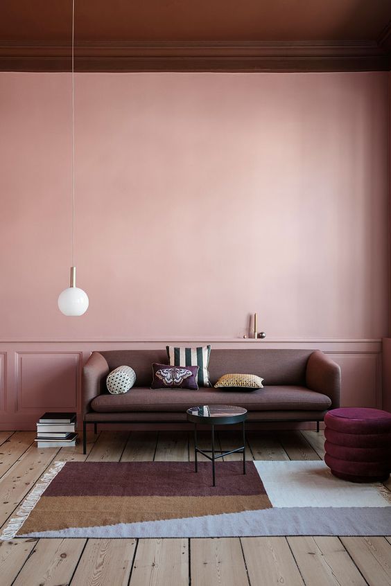 Pink living room walls paired with a burgundy ceiling