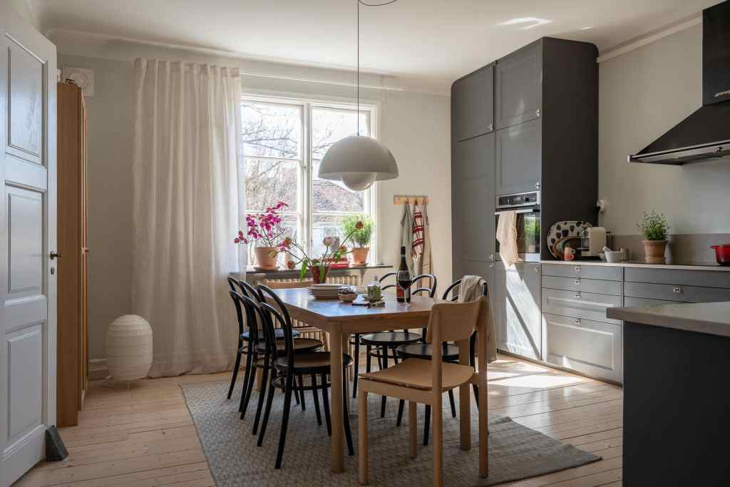 A grey shaker kitchen with a spacious dining table in the middle