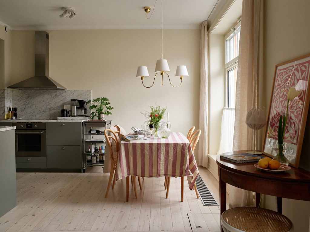 A farmhouse style dining table in an open plan kitchen