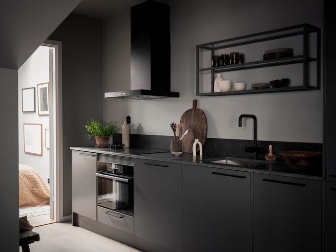 A black kitchen with a one-wall layout and black open shelving