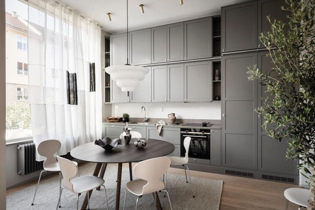 A floor-to-ceiling kitchen with gray cabinets and a one-wall layout