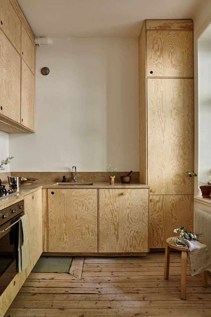 a plywood kitchen in an L-shaped layout
