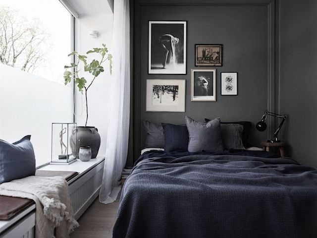 A dramatic dark grey bedroom on a small surface