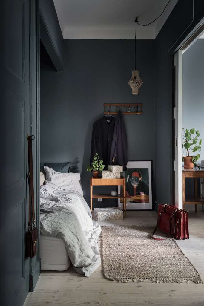 Dark and tiny bedroom space with warm wood tones
